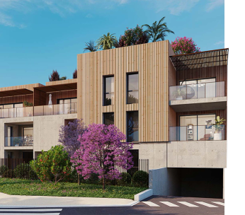 Immeuble résidentiel moderne aux façades beige et blanc, avec balcons, agrémenté d'un buisson en fleurs roses.