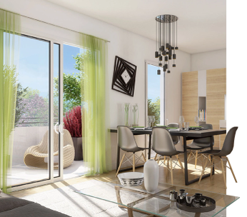 Studio moderne avec cuisine intégrée, lit en bois et coin salon avec fauteuil vert.