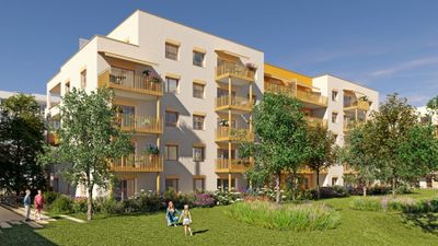 Immeuble résidentiel moderne aux façades jaunes et blanches, entouré d'espaces verts.