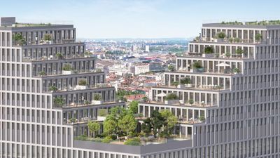 Vue aérienne d'une ville avec immeubles modernes et verdure en arrière-plan