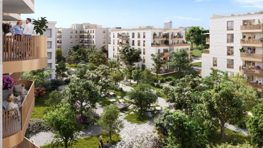 Vue aérienne d'une cour verdoyante entourée d'immeubles résidentiels aux façades claires.