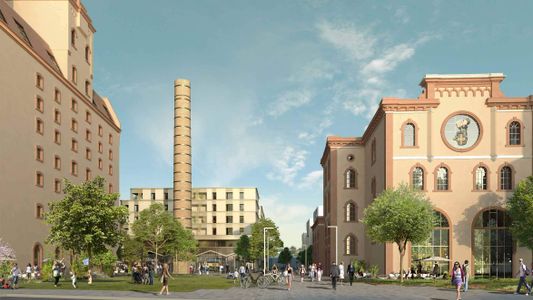Rue urbaine avec bâtiments haussmanniens, tour en arrière-plan et ciel bleu nuageux.
