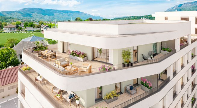 Immeuble résidentiel moderne avec terrasses, entouré de montagnes et d'espaces verts.