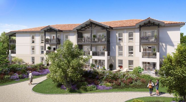 Immeuble résidentiel moderne de trois étages avec façade beige, entouré de végétation verdoyante par beau temps.