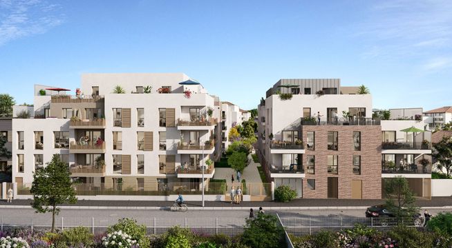 Immeubles résidentiels modernes aux façades beige et rose, avec arbres et ciel bleu en arrière-plan.