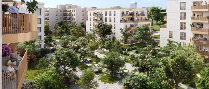 Vue aérienne d'une cour verdoyante entourée d'immeubles résidentiels aux façades claires.